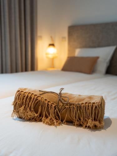 a brown blanket sitting on top of a bed at Quinta da Ribeirinha - Douro River in Paços de Gaiolo