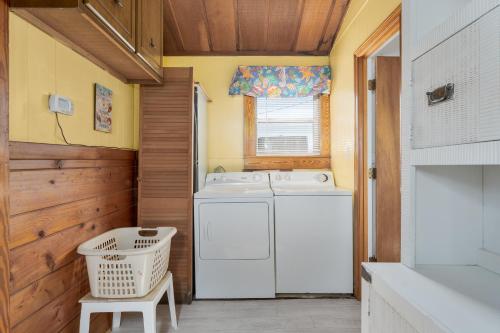 a laundry room with a washing machine and a window at 5453 - Sand Fiddler in Nags Head