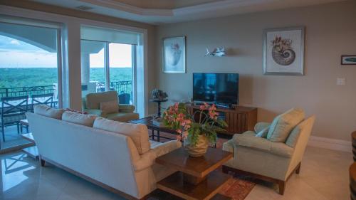 a living room with a couch and chairs and a television at JEEP+ BEST RESORT at Cozumel in Cozumel