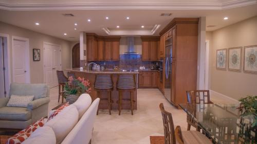 a kitchen and living room with a couch and a table at JEEP+ BEST RESORT at Cozumel in Cozumel