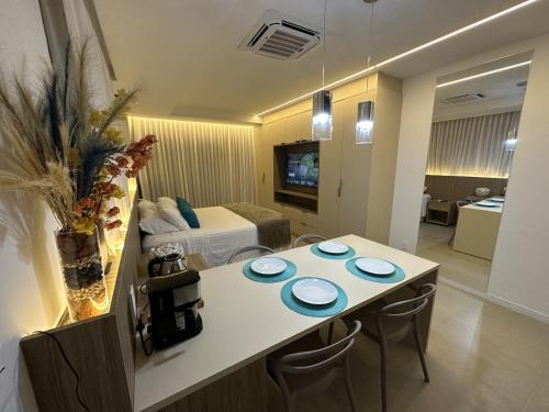 a hotel room with a table with blue plates on it at Boa Viagem - FLAT ROOFTOP 470 - NOVO in Recife