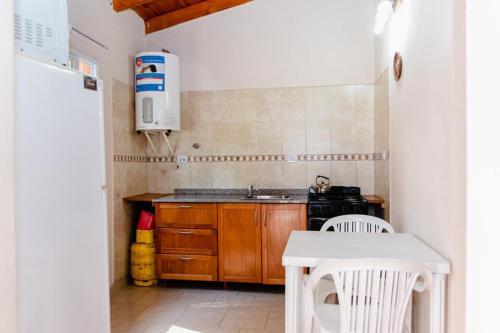 a small kitchen with a sink and a stove at Cabañas Susurros del Río in Trapiche