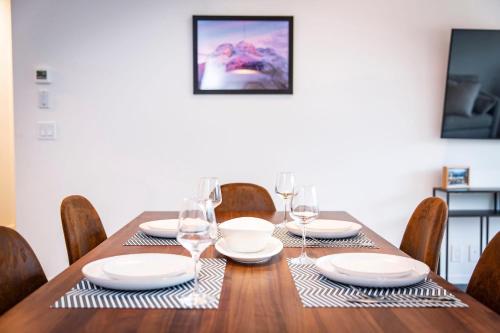a dining room table with glasses and plates on it at The Three Bear Penthouse - with Hot Tub in Revelstoke