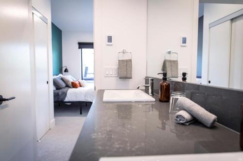 a bathroom with a sink and a large mirror at The Three Bear Penthouse - with Hot Tub in Revelstoke
