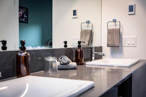 a bathroom counter with two sinks and a mirror at The Three Bear Penthouse - with Hot Tub in Revelstoke