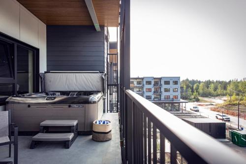a balcony with a stove and a grill on a building at The Three Bear Penthouse - with Hot Tub in Revelstoke