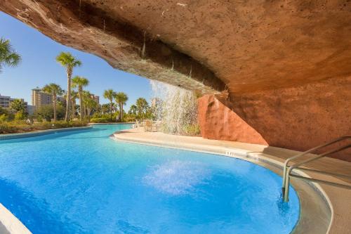 a swimming pool with a water fountain at Luau 6909 in Destin