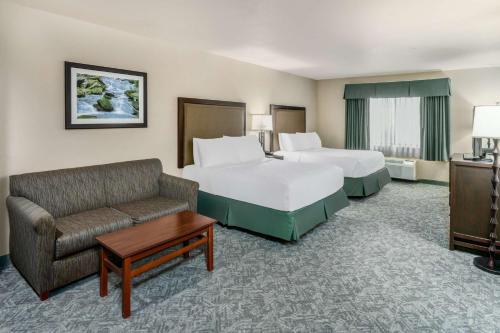 a hotel room with two beds and a couch at Best Western Plus Eagle-Vail Valley in Eagle