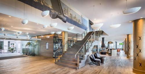 a spiral staircase in a lobby with a stair case at Hilton Auckland in Auckland