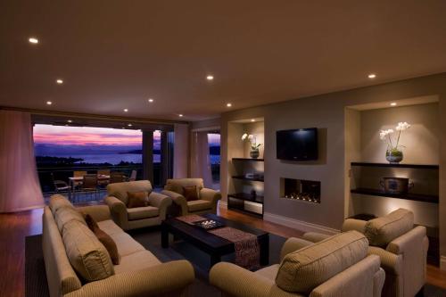 a large living room with couches and a fireplace at Hilton Lake Taupo in Taupo