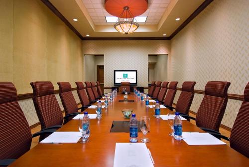 a conference room with a long table with bottles of water at Embassy Suites Murfreesboro - Hotel & Conference Center in Murfreesboro