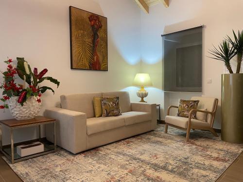 a living room with a couch and a chair at THE ORANGE TREE HOUSES - Terraço by Live and Stay in Abrantes