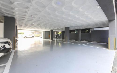 a parking lot with a car parked in a garage at H Avenue Hotel in Gyeongju in Gyeongju