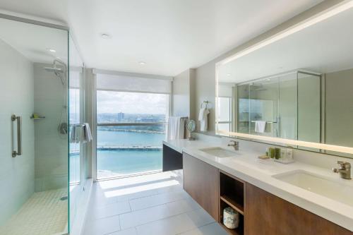 a bathroom with two sinks and a glass shower at Caribe Hilton in San Juan