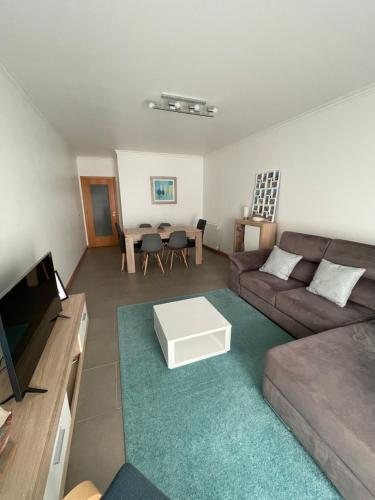 a living room with a couch and a table at GARDEN & BEACH HOUSE in Figueira da Foz