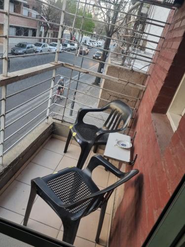 2 sillas en un balcón con vistas a la calle en Departamento terminal Rosario en Rosario