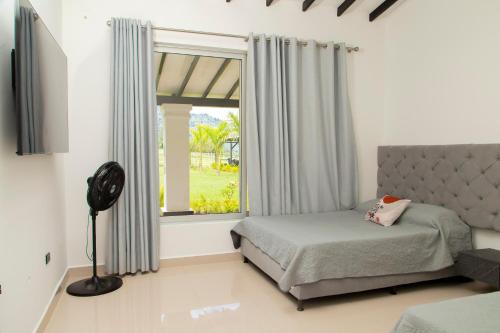 a bedroom with a bed and a window at Espectacular Villa en Copacabana in Copacabana