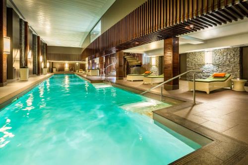 a large swimming pool in a hotel room at Hilton Queenstown Resort & Spa in Queenstown