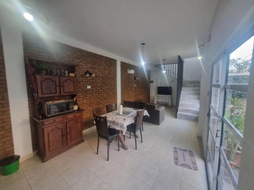 a kitchen and dining room with a table and chairs at Green House.river in Rosario