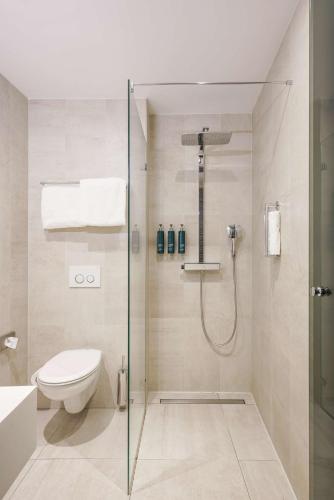 a bathroom with a shower and a toilet at DoubleTree by Hilton Amsterdam - NDSM Wharf in Amsterdam