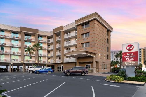 a hotel with cars parked in front of a parking lot at Best Western Plus Daytona Inn Seabreeze in Daytona Beach
