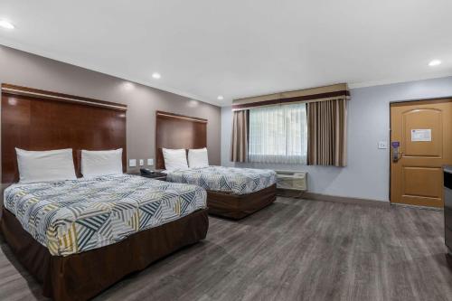 a hotel room with two beds and a window at Motel 6 Carlsbad, Ca- North in Carlsbad