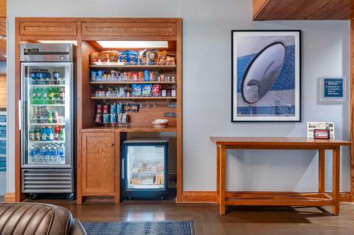 a refrigerator and a table in a room at Bangor Aviator Hotel BW Premier Collection in Bangor