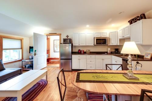 a kitchen and living room with a table and a refrigerator at Acadia Home with Rooftop Deck - Close to Trails! in Otter Creek
