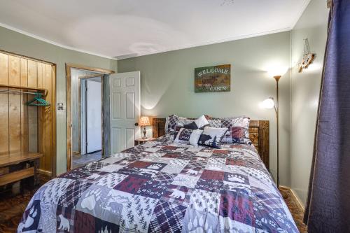 a bedroom with a bed with a quilt on it at Peaceful Cassville Vacation Rental - Hike and Fish! in Cassville