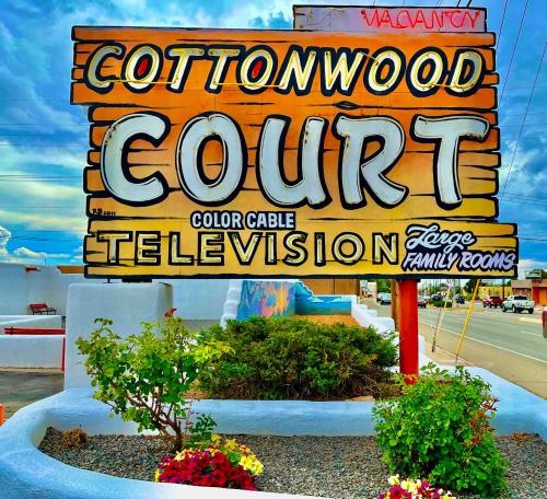 un cartello per un centro golford con fiori in giardino di Cottonwood Court Motel a Santa Fe