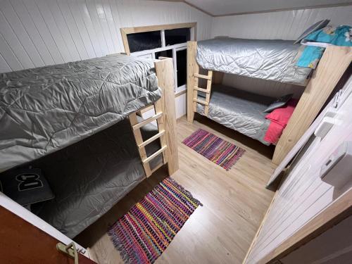 an overhead view of a room with two bunk beds at Refugio Ballena Hostel in Castro