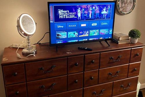 a television on top of a dresser with a mirror at Entire house 3 bedroom Twin Cities, Specious, Entire House, AC in Saint Paul
