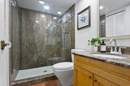 a bathroom with a shower and a toilet and a sink at BRAND NEW, Water Views, 2 BD Condo in Clearwater Beach