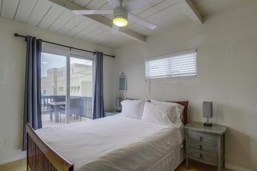 a bedroom with a bed and a large window at OceanCatcher - newly remodeled 3 bedroom retreat with ocean view in the heart of Mission Beach, sleeps 10 in San Diego
