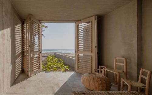 a hallway with a view of the ocean from a house at Casa_Paki in Zihuatanejo