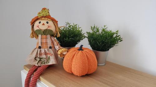a scarecrow and a pumpkin on a shelf at Holiday home Vinovilla in Kutjevo