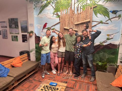 a group of people posing for a picture in a living room at ADVENTURE Hostel in San Gil