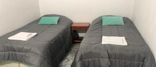 two beds sitting next to each other in a room at Depto Diario en alquiler. Hasta 5 personas in Apóstoles