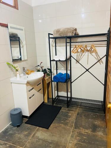 a bathroom with a sink and a mirror and a shelf at Bungalow KURA in Moorea