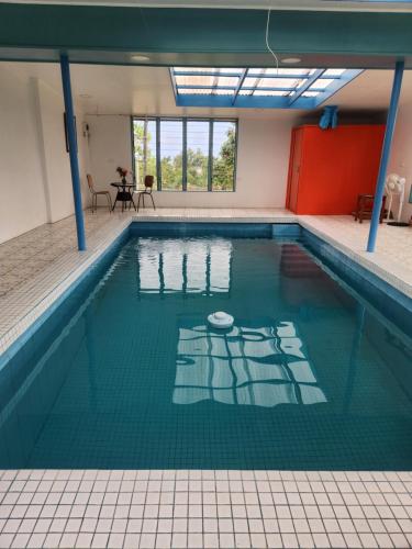 a large swimming pool with a table in the background at Home Away from Home in Suva