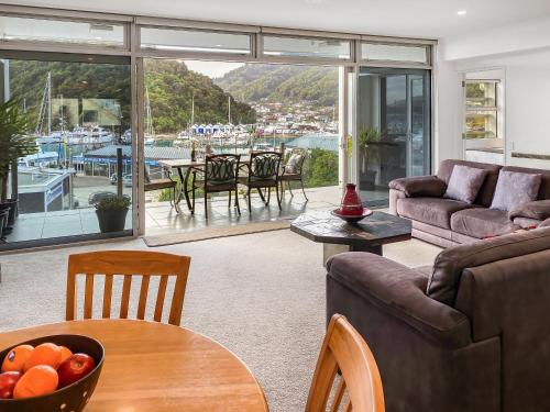 a living room with a view of a marina at Oxley's Waterfront Apartment in Picton