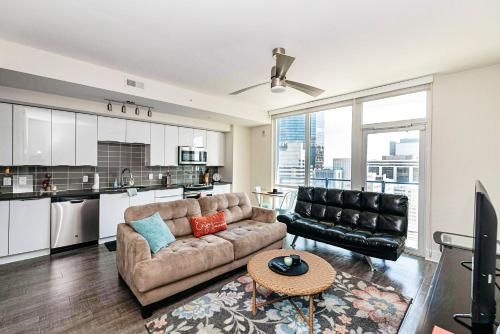 a living room with a couch and a table at Corporate Uptown Furnished Apartments in Charlotte