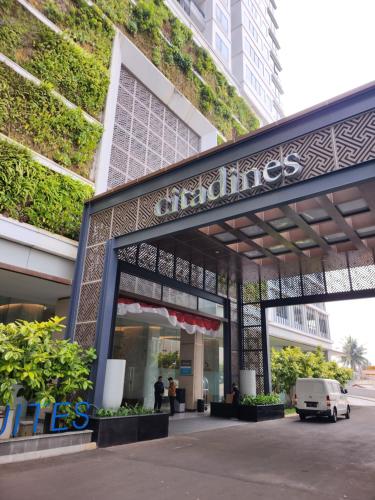a store front of a building with a green wall at Citadines Gatot Subroto Jakarta in Jakarta