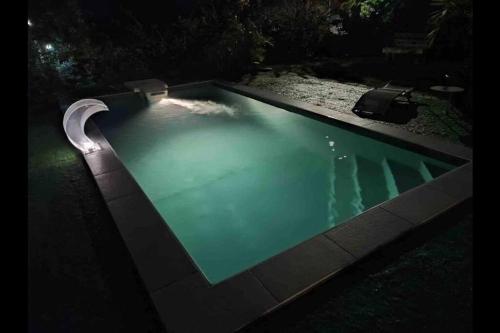 a swimming pool lit up at night at Villa les Maripas T3 in Petit-Canal