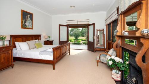 a bedroom with a bed and a fireplace at Reign Manor in Worragee