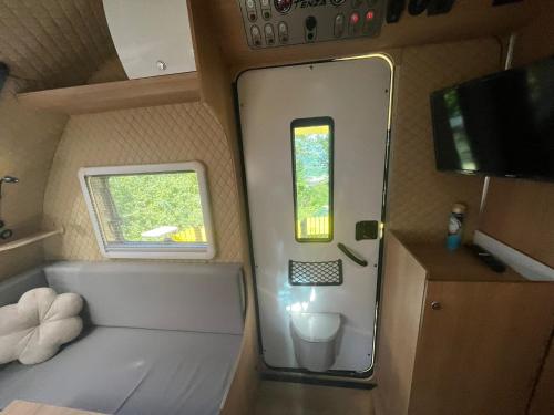a small bathroom with a toilet and a window at Premium Caravan in Sapanca