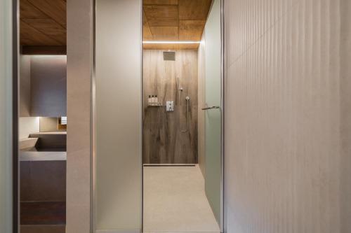 a glass door leading to a shower in a bathroom at Luxury hanok with private bathtub - Happyjae in Seoul