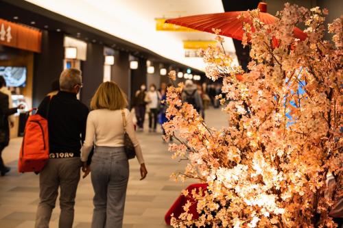 a couple walking through a shopping mall with a christmas tree at Villa Fontaine Premier Haneda Airport in Tokyo