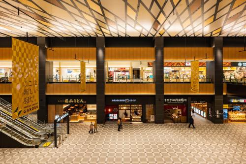 a large shopping mall with people walking through it at Villa Fontaine Premier Haneda Airport in Tokyo