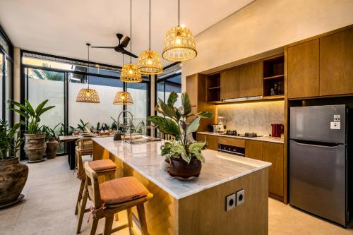 a kitchen with a island with a potted plant on it at Villa Elma by BaliSuperHost in Ubud